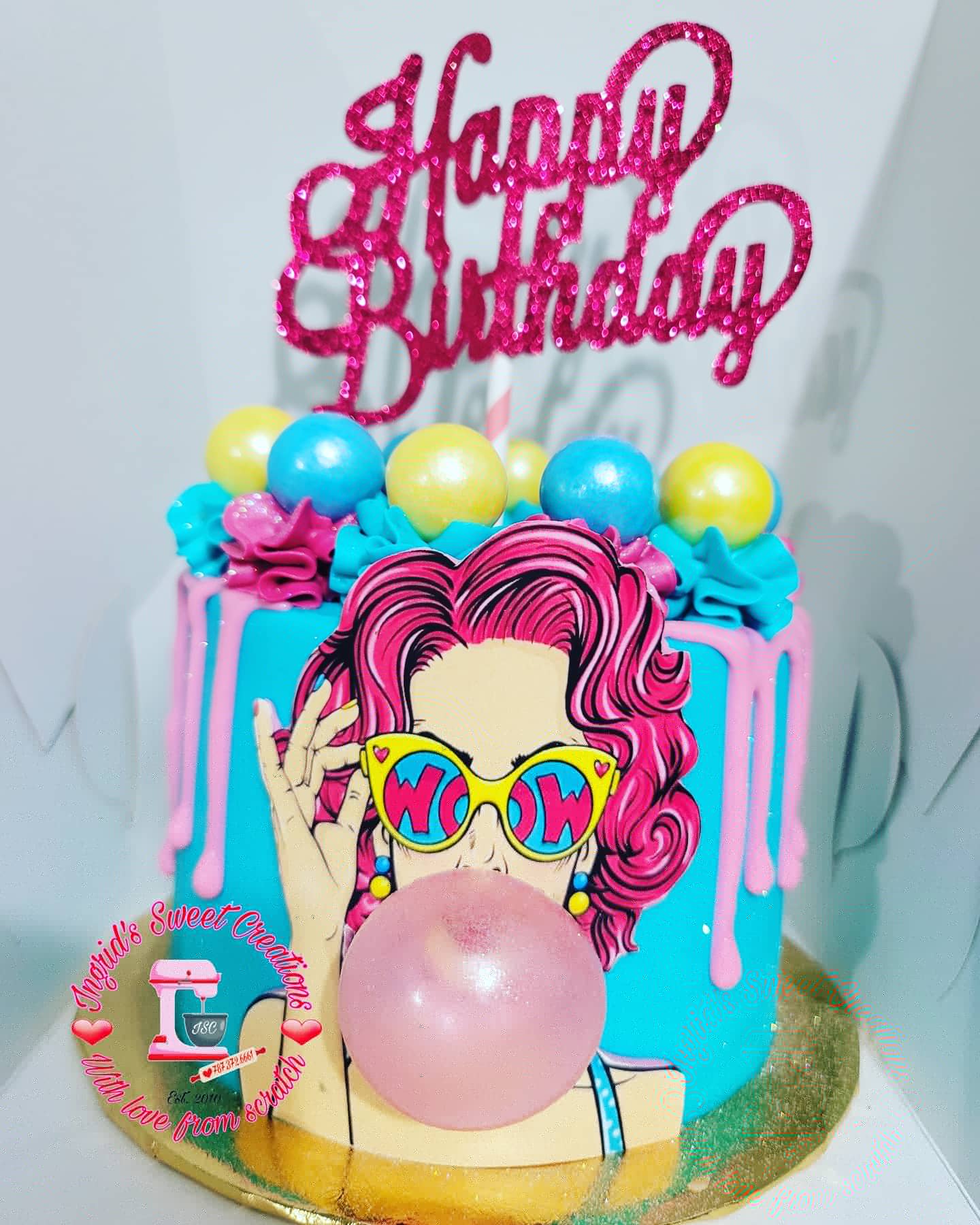 Colorful celebration cake decorated in pink and turquoise.